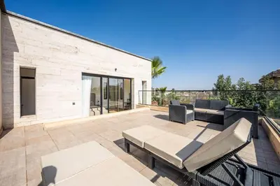 a patio with a couch and chairs on a balcony at Palais Zahira in Marrakech