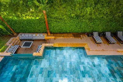 a swimming pool with lounge chairs on a wooden deck at Palais Zahira in Marrakech