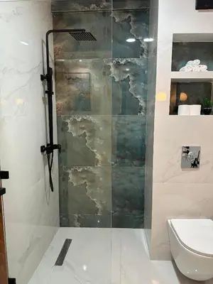 a shower with a glass door in a bathroom at Appartement Moderne à Guéliz in Marrakech