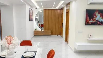 a dining room with a table and red chairs at Appartement Moderne à Guéliz in Marrakech