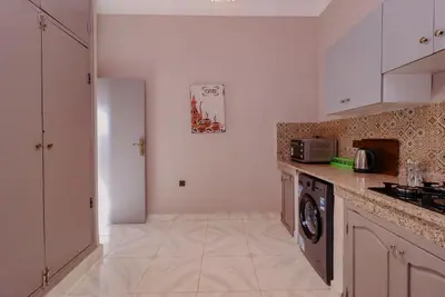 a kitchen with a washer and dryer in it at Maison du Pacha in Marrakech