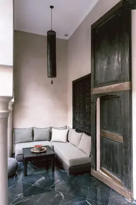a living room with a white couch and a table at Riad K in Marrakech