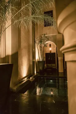 a living room with a pool in the floor at Riad K in Marrakech