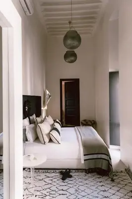 a bedroom with a large bed and a table at Riad K in Marrakech