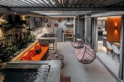 a kitchen and living room with a couch and a pond at Luxury 3 bedroom with private pool and spa in Marrakech