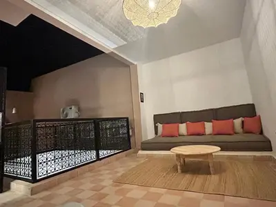 a living room with a couch and a table at Welcome to Riad Mariam & Maïwenn! in Marrakech