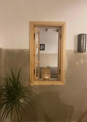 a mirror on a wall with a plant in a room at Welcome to Riad Mariam & Maïwenn! in Marrakech