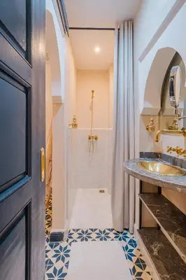 a bathroom with a sink and a shower at Riad ZEROUAL in Marrakech