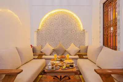 a living room with a couch and a table at Riad ZEROUAL in Marrakech