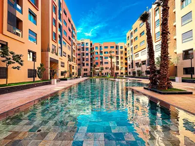 a swimming pool in the middle of a building at Le Pavillon Gueliz Appart Chic Confort et Piscine in Marrakech