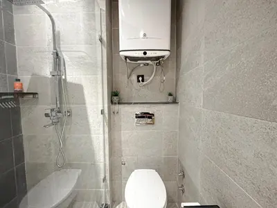 a small bathroom with a toilet and a shower at Le Pavillon Gueliz Appart Chic Confort et Piscine in Marrakech