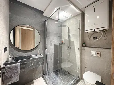 a bathroom with a shower and a sink and a toilet at Le Pavillon Gueliz Appart Chic Confort et Piscine in Marrakech