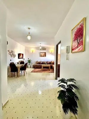 a living room with a table and a couch at Zyarat Marrakech in Marrakech