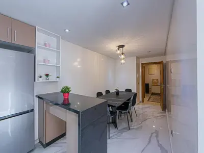 a kitchen and dining room with a table and chairs at Essalmi Luxury Apartment Gueliz in Marrakech