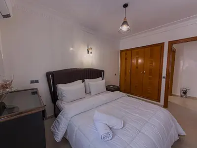 a bedroom with a large bed with white sheets and pillows at Essalmi Luxury Apartment Gueliz in Marrakech