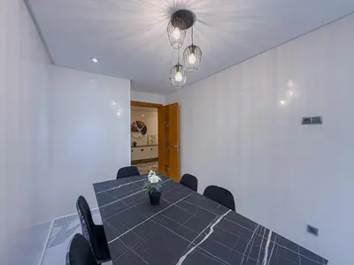 a dining room with a table and chairs at Essalmi Luxury Apartment Gueliz in Marrakech