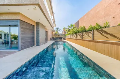 an indoor swimming pool in the backyard of a house at villa golfe in Marrakech