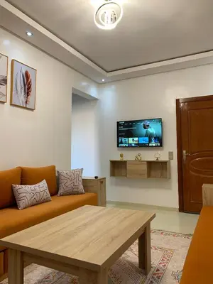 a living room with a couch and a table at New Apart Marrakech 2 BR-5 MN from airport in Marrakech