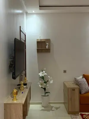 a living room with a tv and a couch at New Apart Marrakech 2 BR-5 MN from airport in Marrakech