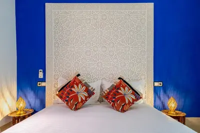 a bedroom with a white bed with two pillows at Riad with Rooftop Terrace in Top Medina Location, Dar El Bacha in Marrakech