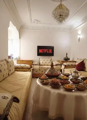 a living room with a table with food on it at Dar'ESTRELLA calme 15min Jemaa ElFna parking free in Marrakech