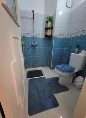 a blue tiled bathroom with a toilet and a shower at Dar'ESTRELLA calme 15min Jemaa ElFna parking free in Marrakech