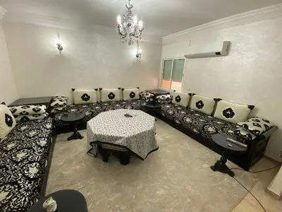 a living room with a couch and a table at Bouchouk Apparts Gueliz in Marrakech