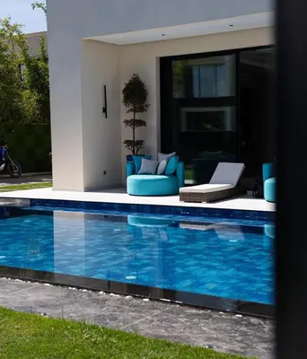 a swimming pool in front of a house at Villa California in Marrakech