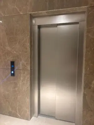 a elevator door in a bathroom with a stone wall at New apartment - Gueliz - Pool in Marrakech