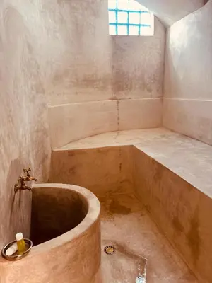 a bathroom with a large tub and a sink at Riad Blue Berry in Marrakech