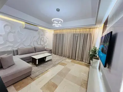 a living room with a couch and a table at Modern & Central Apartment in Marrakech