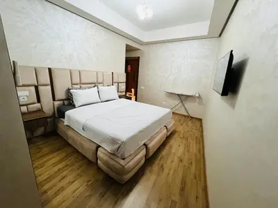 a bedroom with a bed and a television in it at Modern & Central Apartment in Marrakech