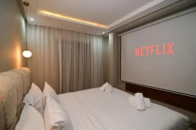 a hotel room with a bed and a projection screen at Downtown Prestige 2Br apartment cinema AC in Marrakech