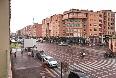a city street with cars parked in a parking lot at Downtown Prestige 2Br apartment cinema AC in Marrakech
