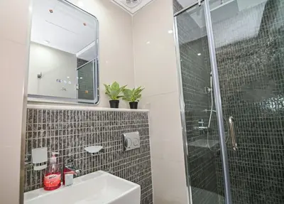 a bathroom with a sink and a glass shower at Downtown Prestige 2Br apartment cinema AC in Marrakech