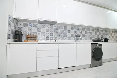 a kitchen with white cabinets and a dishwasher at Downtown Prestige 2Br apartment cinema AC in Marrakech