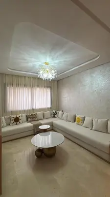 a living room with a couch and a table at Luxurious 2 Bedrooms in Gueliz Pool View in Marrakech