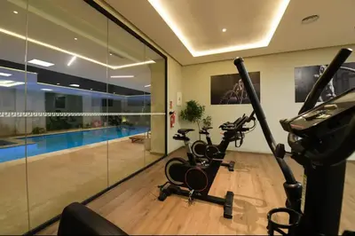 a gym with two exercise bikes and a swimming pool at Luxurious 2 Bedrooms in Gueliz Pool View in Marrakech