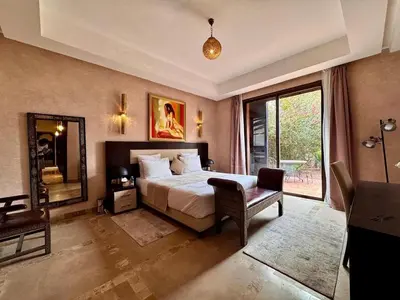 a bedroom with a bed and a large window at Marrakech Luxury Escape Full Villa Pool & Garden in Sraghna