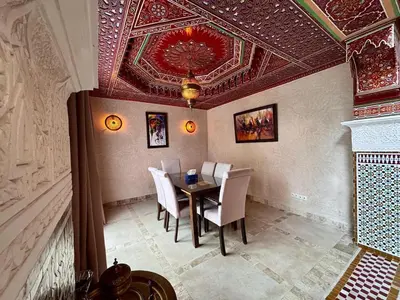 a dining room with a table and chairs and a ceiling at Marrakech Luxury Escape Full Villa Pool & Garden in Sraghna