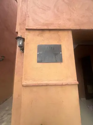 a sign on the side of a building with a street light at Marrakech Luxury Escape Full Villa Pool & Garden in Sraghna
