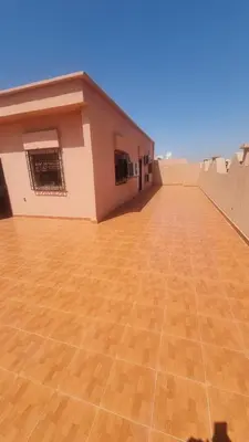 an empty roof of a house with a wooden floor at Appartement Atlas in Marrakech