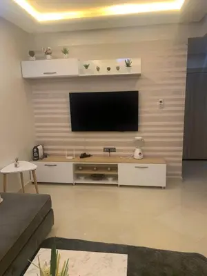 a living room with a flat screen tv on a wall at 2 Bedroom Apartment Calm Area Parking in Marrakech