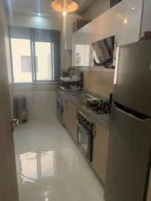 a kitchen with a refrigerator and a stove top oven at 2 Bedroom Apartment Calm Area Parking in Marrakech