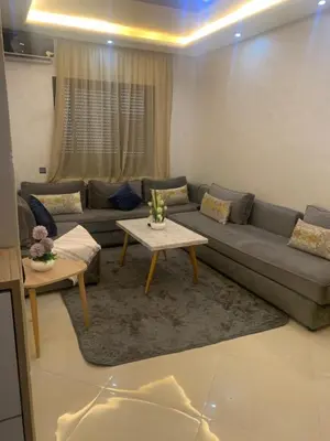 a living room with a couch and a table at 2 Bedroom Apartment Calm Area Parking in Marrakech