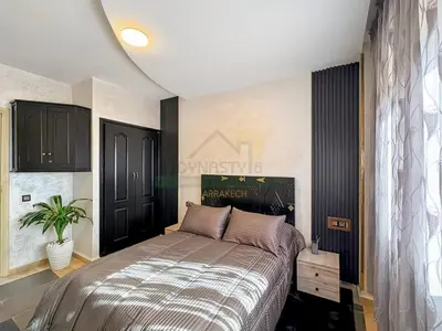 a bedroom with a bed and a potted plant at Confort Moderne au Cœur de Marrakech Proche Gare in Marrakech