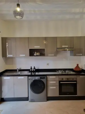 a kitchen with a washing machine and a sink at Marrakchi Home, Vintage Terrace Overlooking Pool in Marrakech