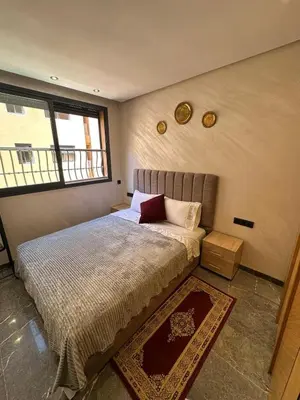 a bedroom with a large bed with a window at City Chic New build Apartment in Marrakech