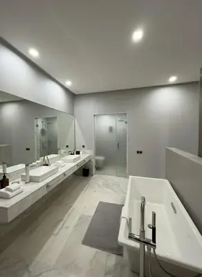 a large bathroom with three sinks and two mirrors at Villa Oasis de Verre - Atlas Golf & Pool in Marrakech
