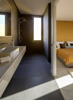 a bathroom with a bed and a sink and a tub at Villa Oasis de Verre - Atlas Golf & Pool in Marrakech